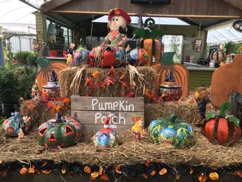 Painted pumpkins on a hay bale display